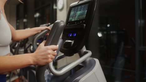 woman working out on a cross trainer in a gym