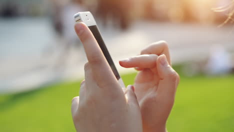 close-up womans hands using touchscreen phone