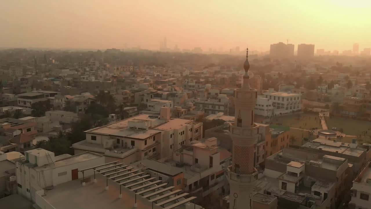 Aerial Past Minaret On Mosque In Karachi During Golden Orange Sunset