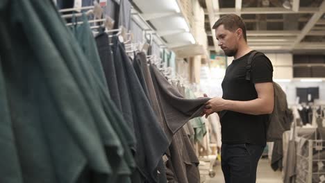 man shopping for towels in a retail store