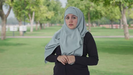 scared and afraid muslim woman in park