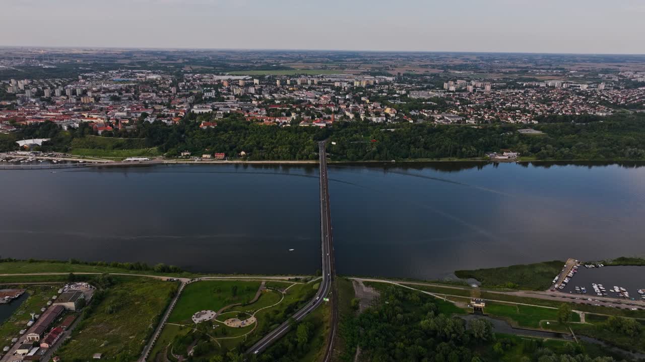 Cinematic aerial perspective of bridge, Vistula River, Plock Poland cityscape