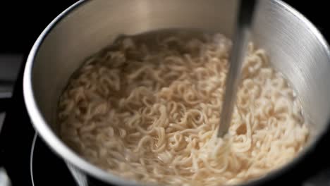 spinning instant noodles in the boiling pan