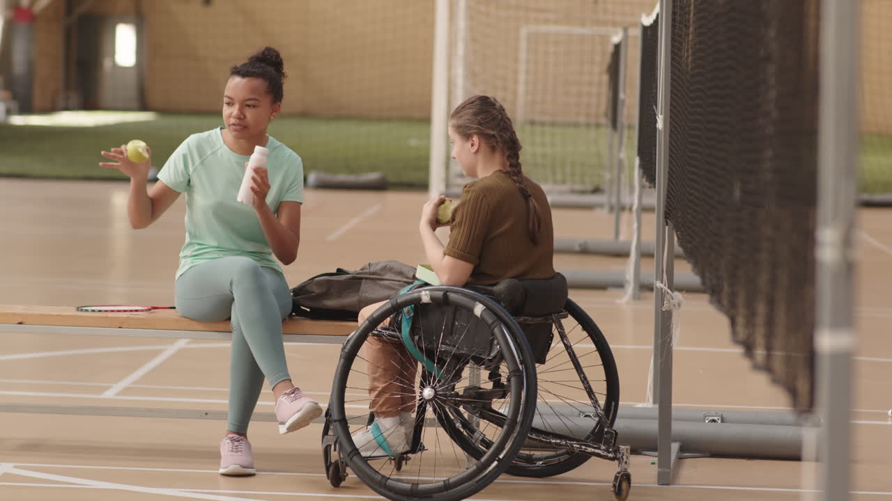 Diverse Female Athletes Talking in Gym