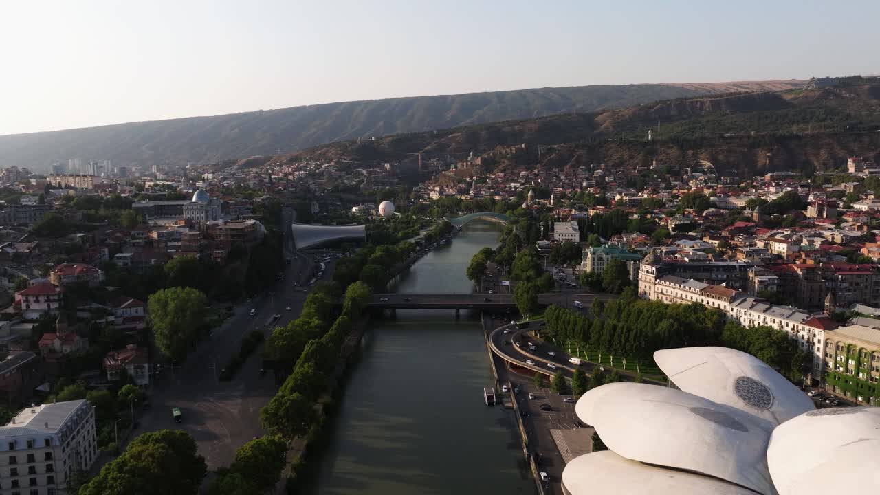 Cinematic Aerial View Above Kura River in Downtown Tbilisi, Georgia. Sunrise