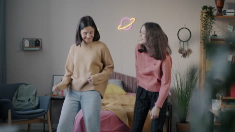 sisters dancing in their bedroom