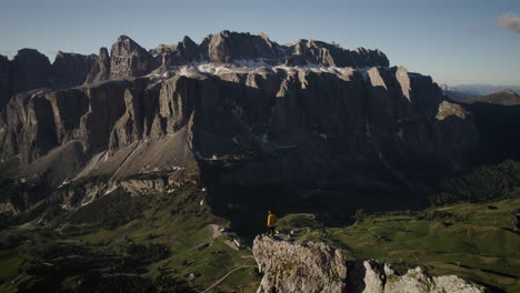 alpinist stands on gan cir peak, view of dramatic dolomites