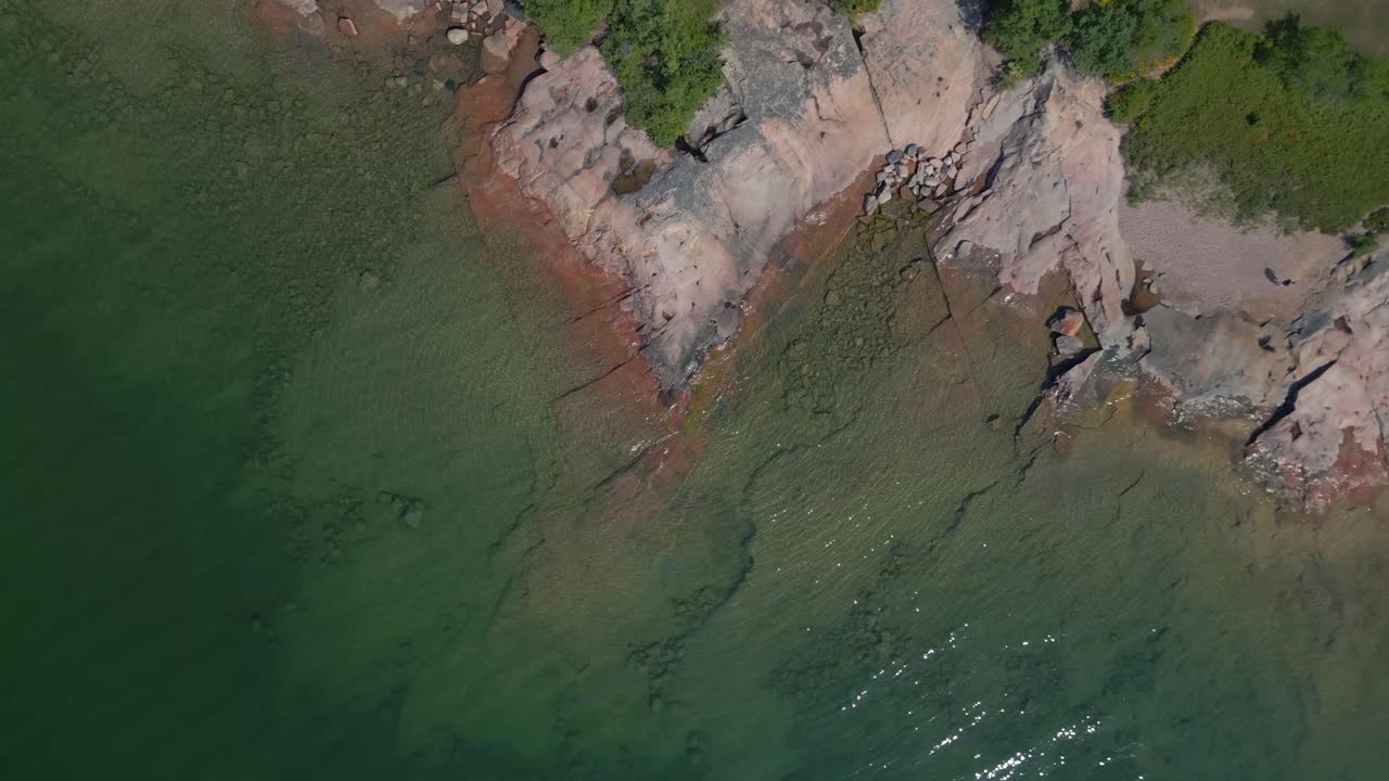 Aerial View of Clear Green Water and Rocky Coastline