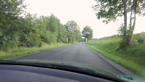 Driving-a-car-from-a-first-person-perspective-in-the-summer-countryside-of-the-Czech-Republic