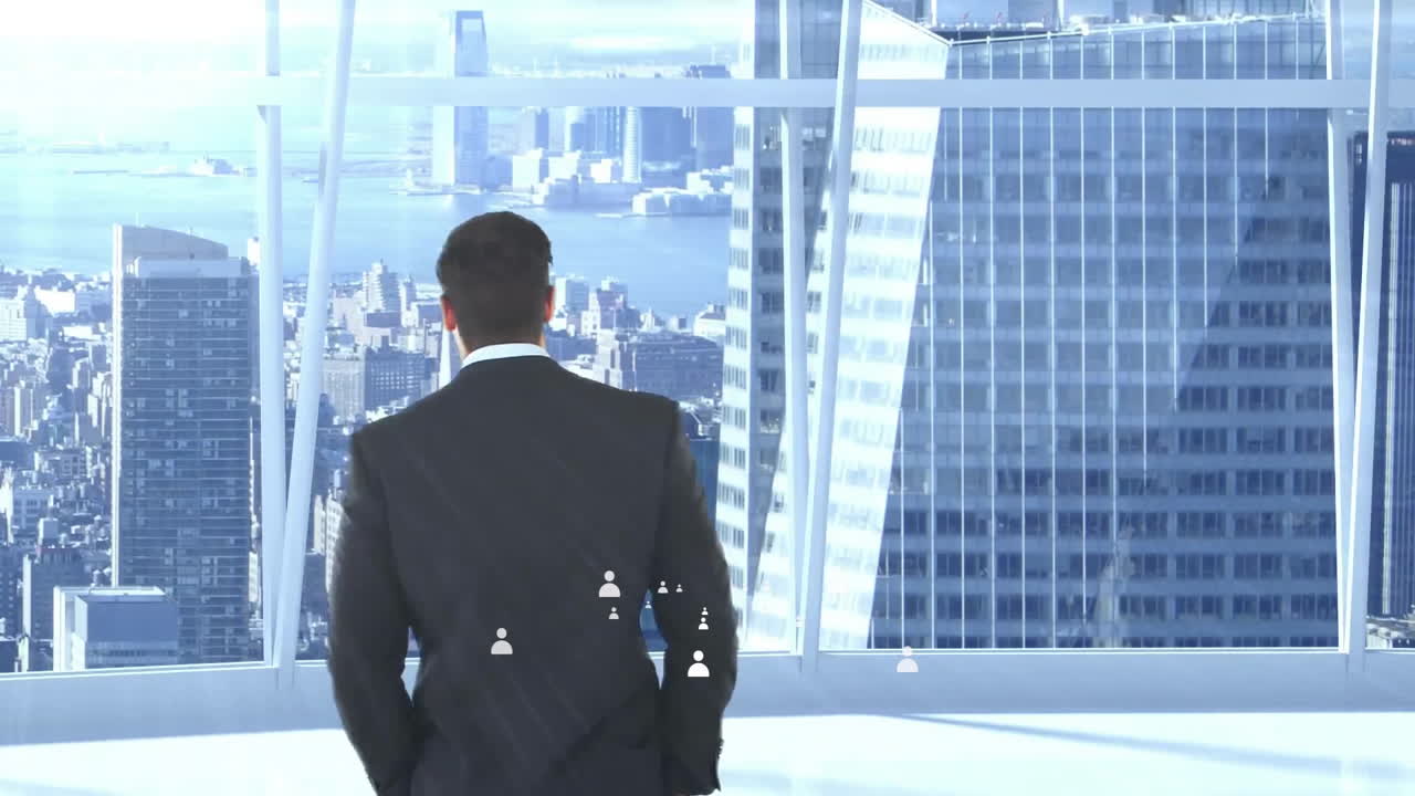 Businessman in suit looking at city skyline with animation of digital network icons