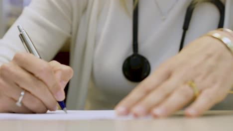 doctor writing a prescription, medical report in the office of the clinic