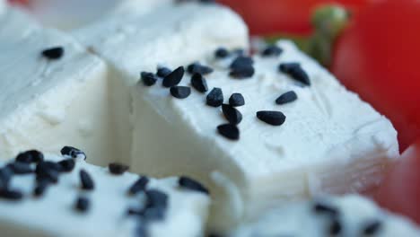 close-up of cubed white cheese with black seeds