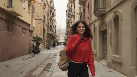 Young-girl-smiling-and-looking-at-the-camera-in-the-street