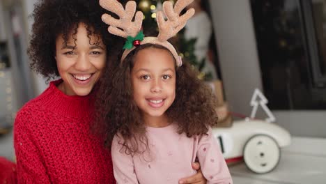 Handheld-view-of-African-girl-and-her-mommy-at-Christmas