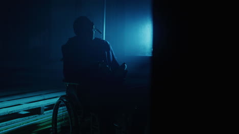 Silhouette of a Person in a Wheelchair in the Dark
