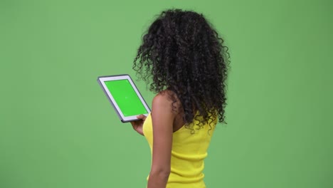 young beautiful hispanic woman using digital tablet