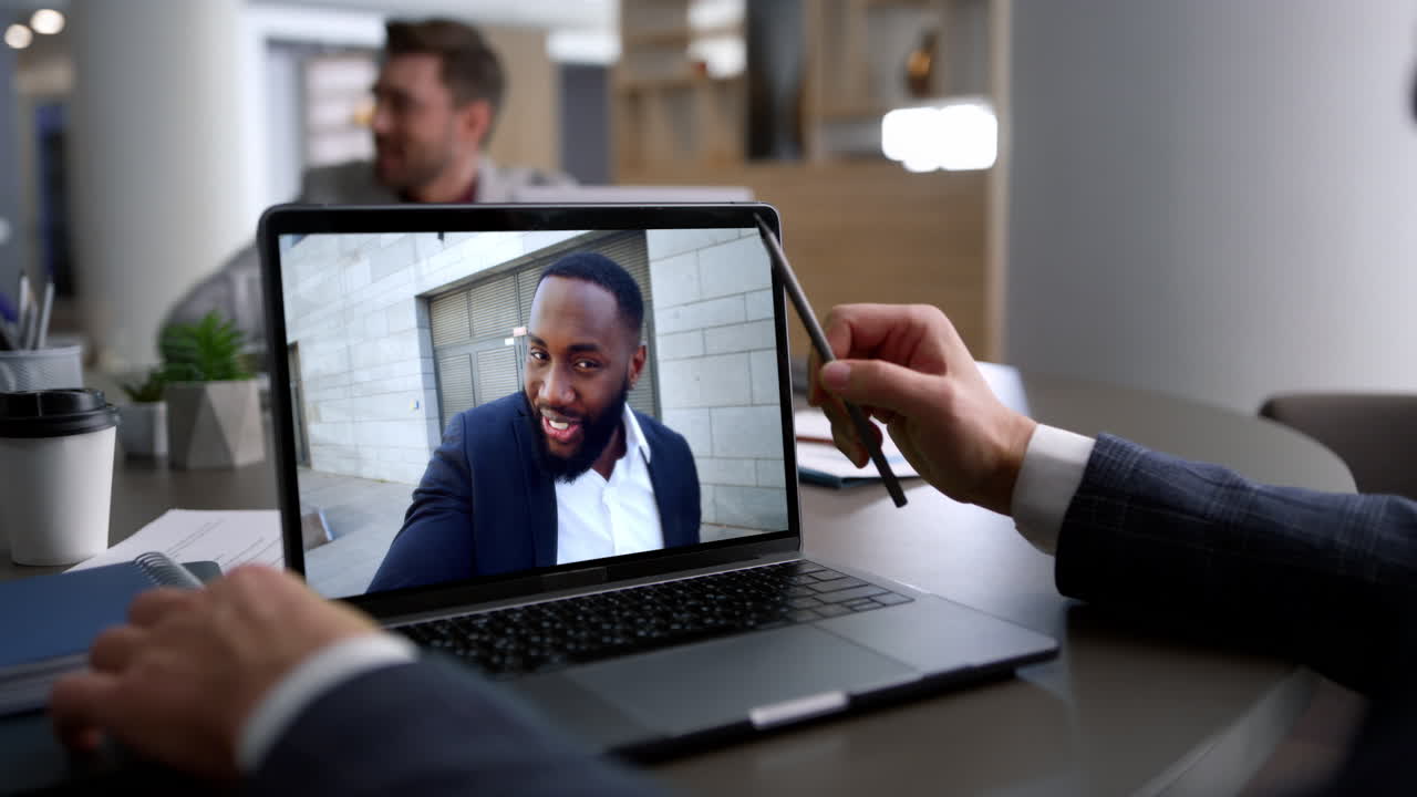 Business manager talking laptop screen in corporate coworking office close up