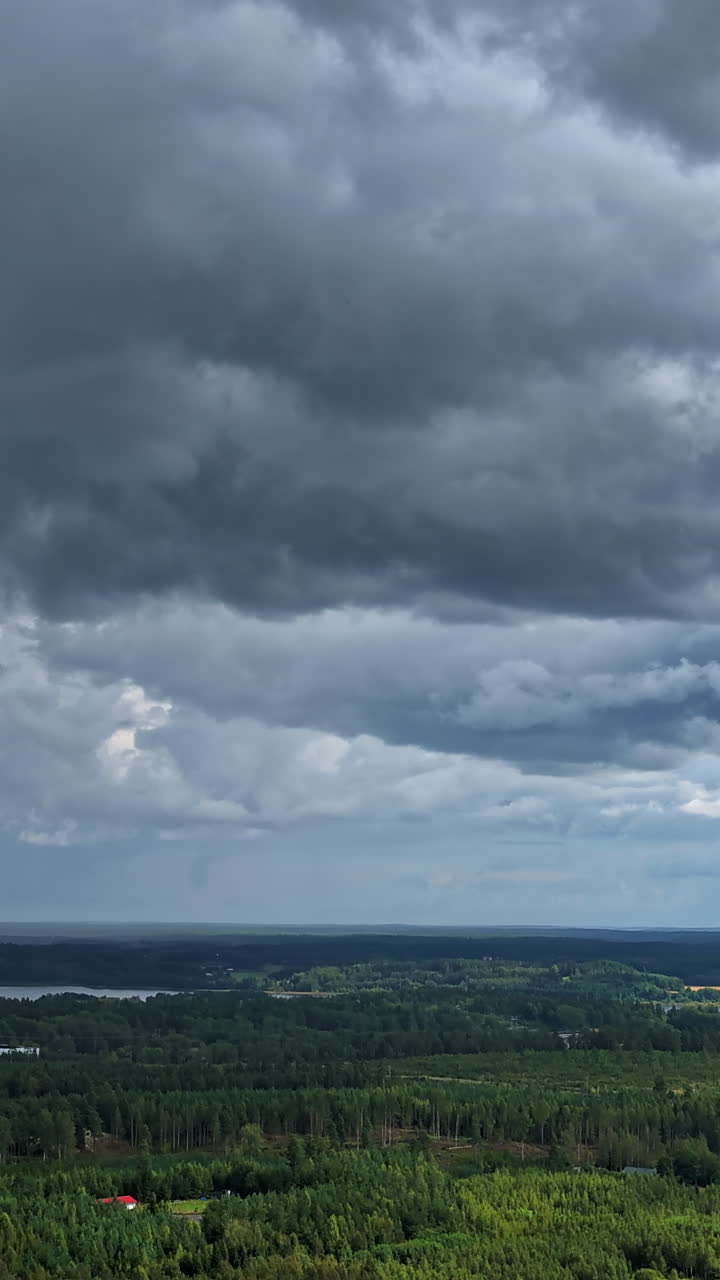 Vertical hyperlapse rotating in front of storm clouds above the countyside