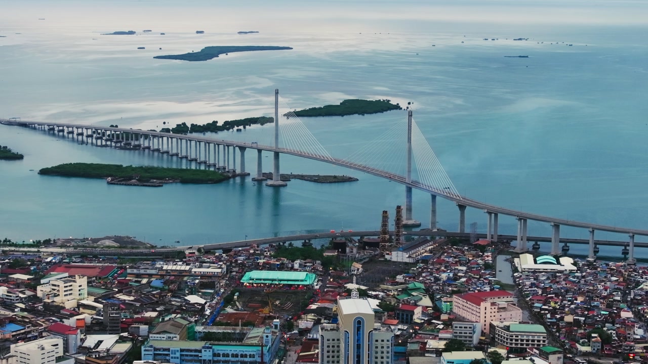Expansive view of Cebu City with bridge over sea and dense urban landscape below