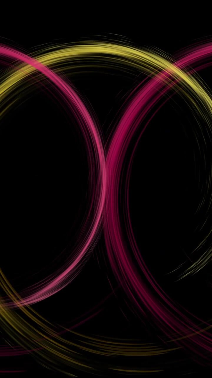 Animation of colourful light trails forming circles on black background