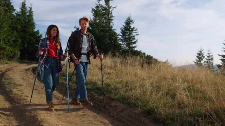 Smiling man and woman walking in mountains