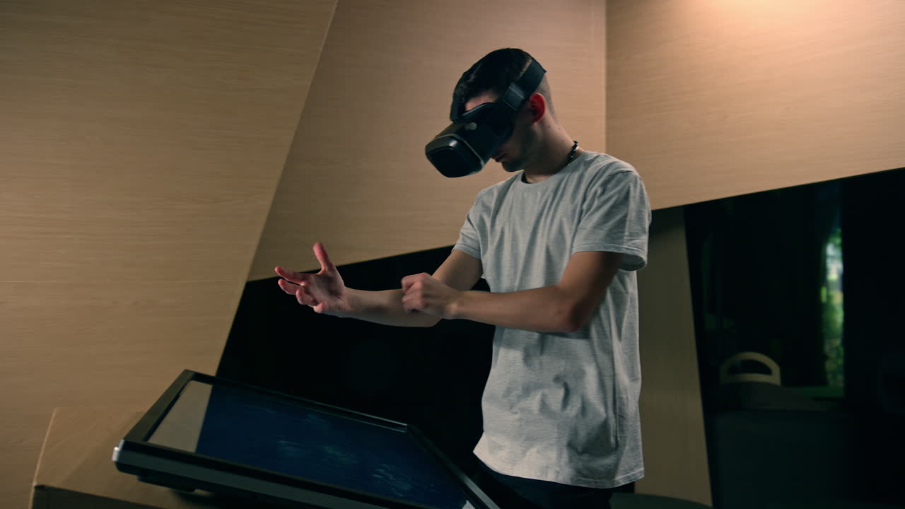 Man using a VR headset with motion tracking tech, make hand gestures in the air
