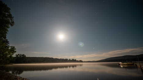 moon rises and sets over beautiful lake after sundown amazing view of stars and sunrise