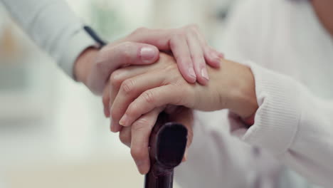 Caregiver,-hands-and-elderly-woman-with-cane