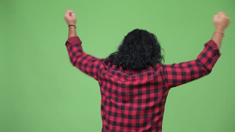 rear view of hipster man cheering with fists raised