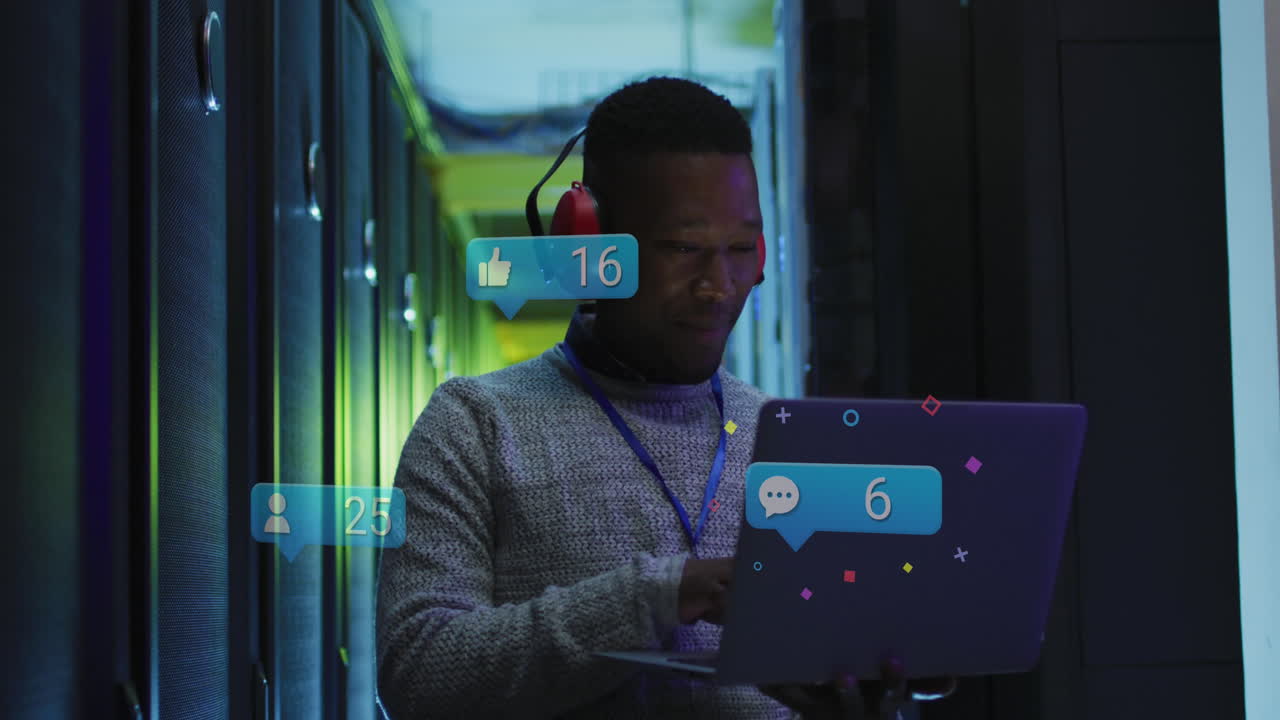 Animation of social media icons over african american male engineer using laptop at server room