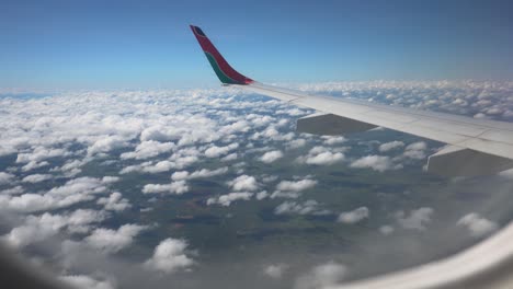 airplane wing shot from inside plane flying over zambia