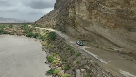 a jeep truck driving on beautiful and dangerous road in hingol baluchistan pakistan exploring the road