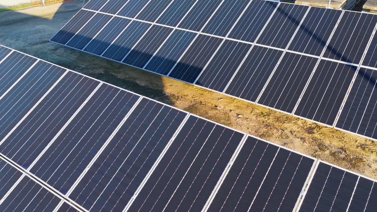 Aerial view of solar panels in a sunlit farm setting, capturing renewable energy efficiently