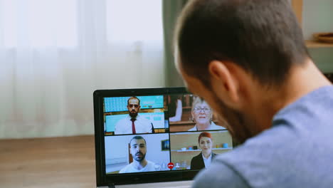 zoom out shot of man on a video call