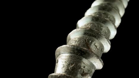 close-up of a metal screw thread on black background