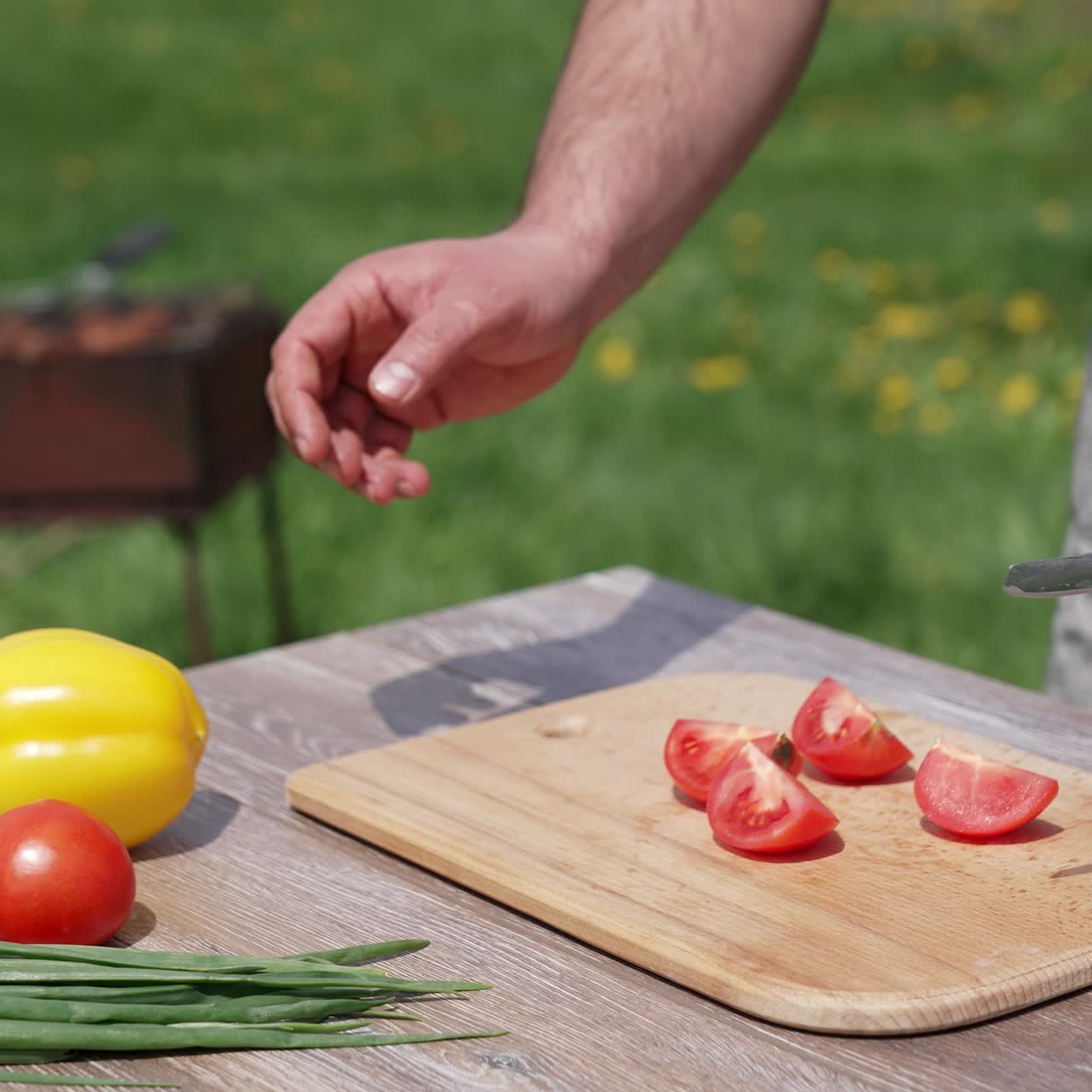 Human hands cutting ripe tomatoes. Organic slicing vegetables