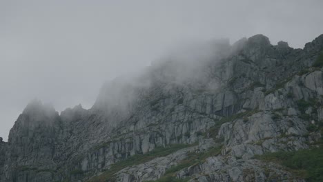 clouds going through a granite wall on the distance