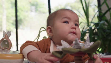 beautiful asian baby looking up and smiling happily