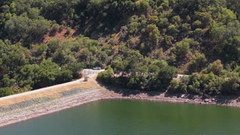 drone glides over uvas reservoir, unveiling its deep blues and green shores framed by morgan hill’s rugged charm
