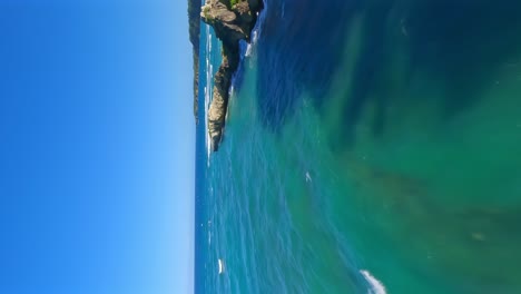 fpv flight along coastline and beach breton during sunny day with clear water of sea in dominican republic