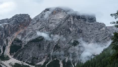 developing clouds moving around rugged dolomites extreme rocky mountain range