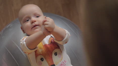 baby girl on gymnastic ball