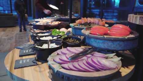 fast camera shot over breakfast buffet in a hotel - a man takes a sandwich