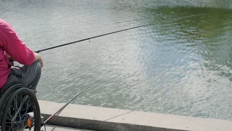 person with a physical disability who uses wheelchair fishing from fishing pier