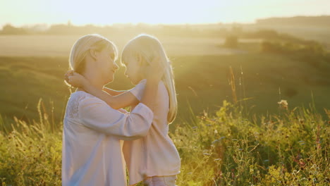 A-Young-Mother-Calming-Her-Child-Stroking-Her-Blond-Hair-Outdoors