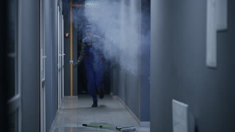 janitor encounters smoke in a hallway