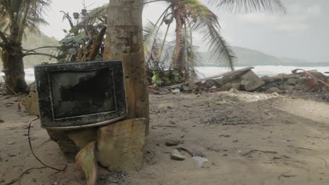broken tv washed ashore on a pristine beach near capurganá, colombia — beauty meets pollution in a surreal coastal scene.