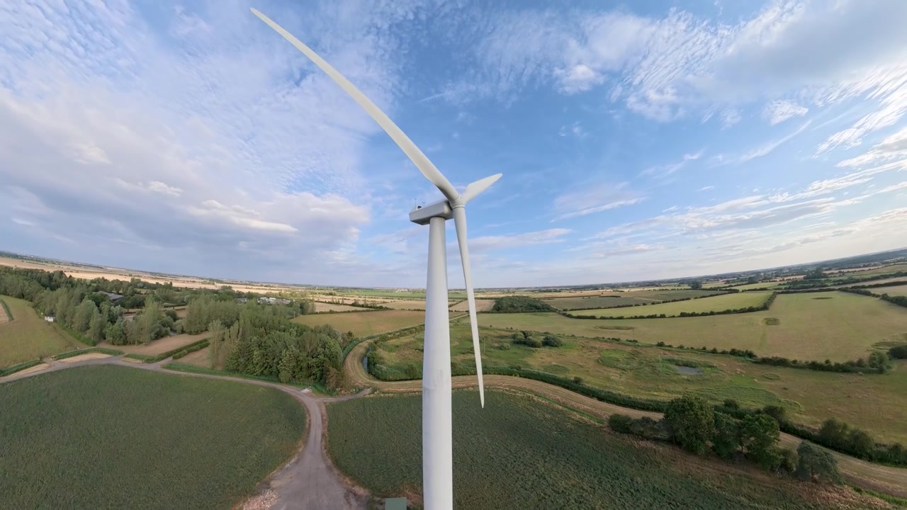 aerial drone footage, Sunset view over a field of renewable energy sources featuring wind turbines and natural scenery. Lincolnshire solar panel arrays wind turbines countryside, England