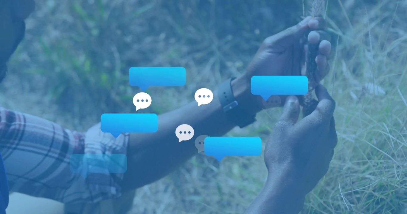 Man plucking grass in field, causing blue bubbles emerging then fading around smartwatch for tech