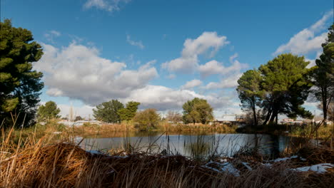 a small section of the beautiful central park lake in new york with clouds rolling overhead - time lapse